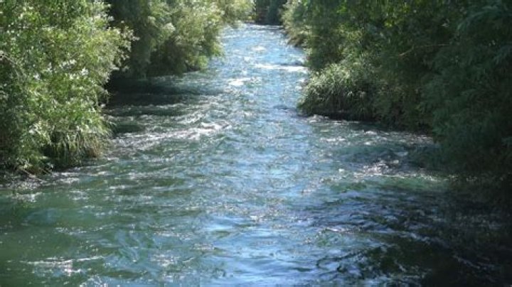 a river flowing in a hilly landscape