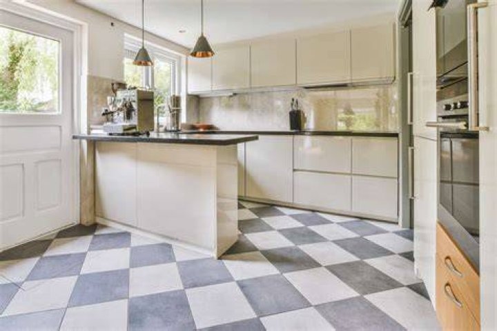 Floor tiled with two sizes of square tiles